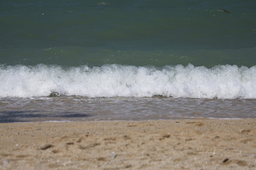 Tidal bore. Waves roll on the sandy shore.