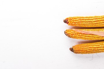 Dried corn on a wooden background. Top view. Copy space.