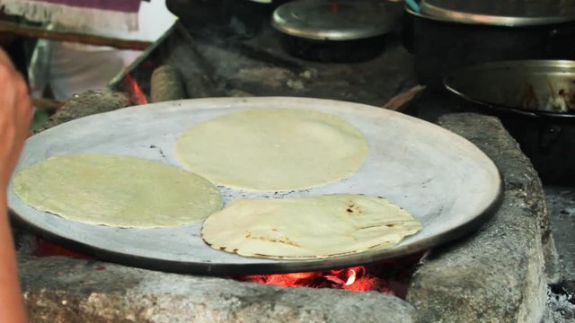 traditional Mexican food, tortillas made in clay and wood comal