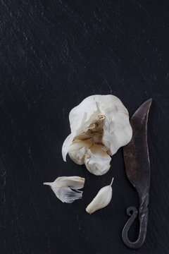 Cloves of garlic with old knife