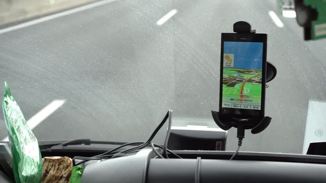 GPS navigation tracking vehicle location and route while driving on road. GPS navigation on smartphone showing route.