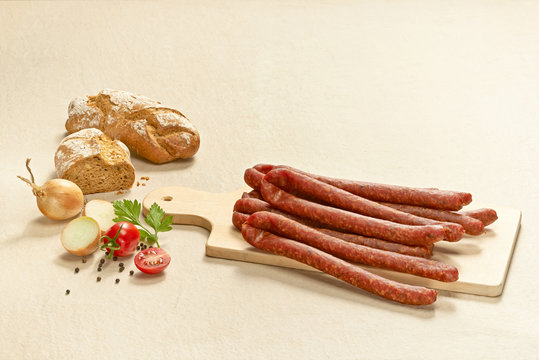 Pfefferpeitschen, pork sausages on chopping board