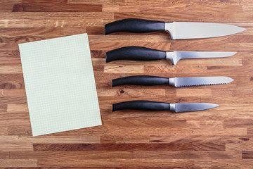 set of four chopping knives chef on a cutting Board oak