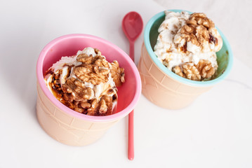 Panna cotta ice cream decorated with walnuts.