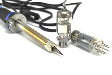 Radio components and electric soldering iron on white background close-up 