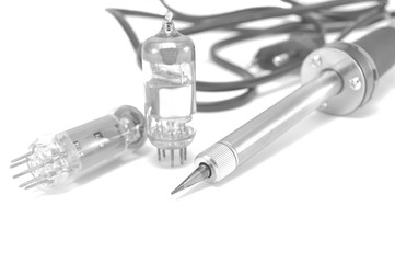 Radio components and electric soldering iron on white background close-up 