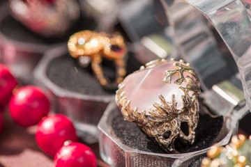 Macro shot of silver engagement ring in gift box on colorful, sparkling background. Rose Quartz Crystal is rose pink colored quartz that aids all types of relationships. powerful healing crystal