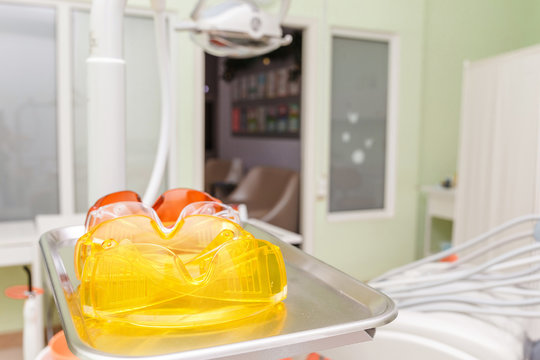 plastic protective work glasses in dentist office - Powered by Adobe