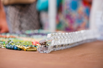 Engagement rings in boxes in a row on colorful background. Expensive, luxury jewelry made of gemstones. Chalcedony stone wedding ring