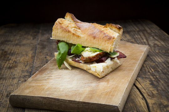 Sandwich, French white bread, smoked ham, basil, dried tomatoes and parmesan
