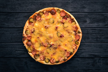 Homemade pizza on a wooden background. Top view. Copy space.