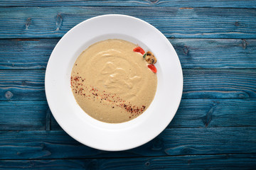 Mushroom puree soup. On a wooden background. Free space for your text. Top view.