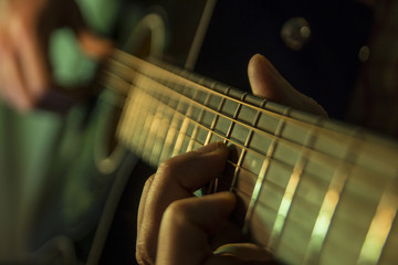 Practicing in playing guitar. Handsome young men playing guitar