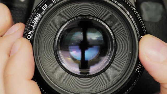 photographer taking picture, close dslr lens