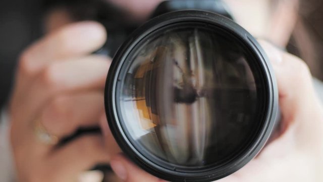 photographer taking picture, close dslr lens