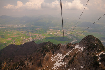 View of the Salzburg basin and the cable car rope from the Untersberg mountain top.