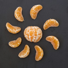 slices of mandarin on a black background. 