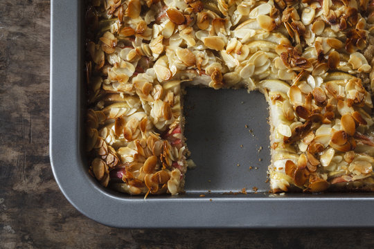 Baking tray of whole meal apple pie with sliced almonds