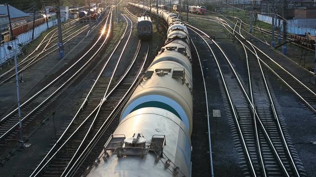 Freight train passing by at sunset