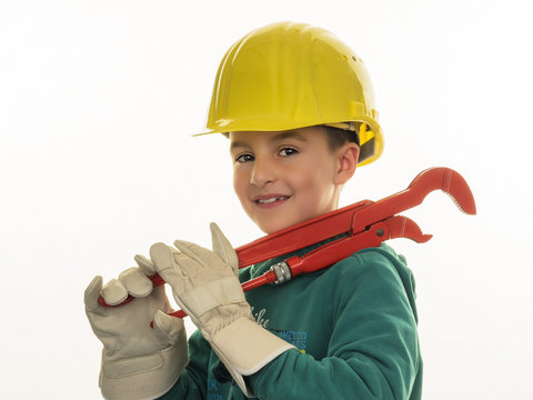 Portrait of boy with hard hat holding large pliers