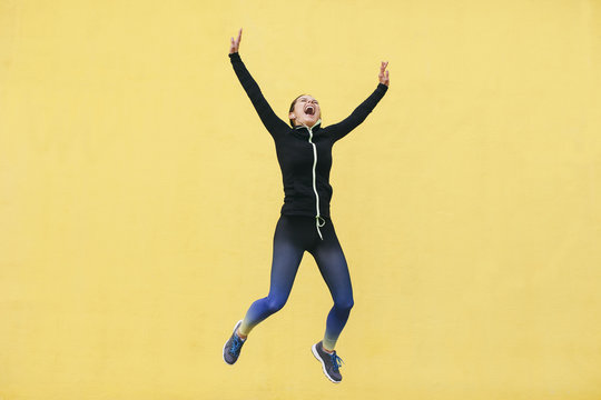 Spain, Barcelona, female jogger jumping