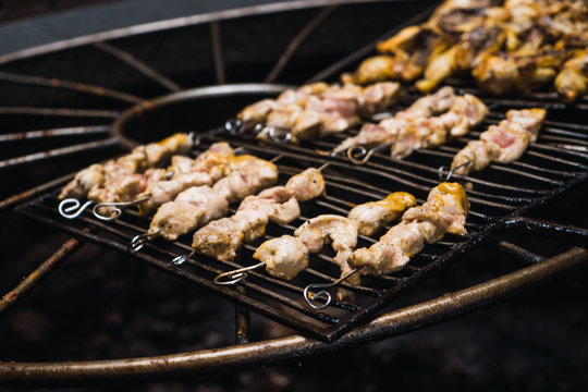 Half-sliced chickens grilling