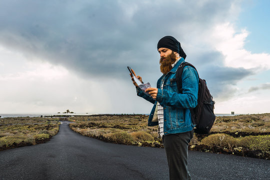 Tourist man with map and smartphone