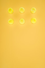 Tennis balls in a row isolated on orange background