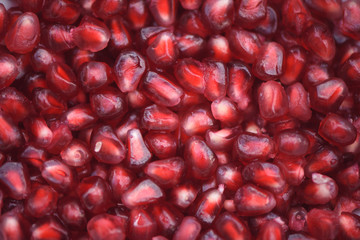 abstract background photography image of close up macro with bright red juicy and delicious pomegranate fruit for healthy living and full of vitamins and minerals