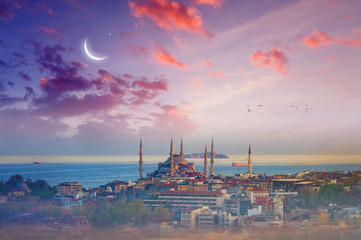 Blue Mosque, glowing sunset with crescent in Istanbul, Turkey