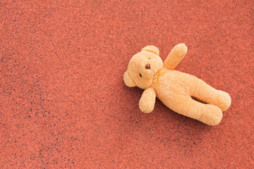 bear toy on red floor ,top view