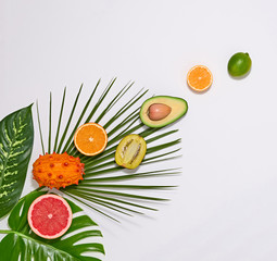 Creative Tropical Layout. Palm Leaves and Fresh Fruits. Colorful Summer Design Set. Healthy Art Food concept. Nature Bright Summer background. Flat lay.