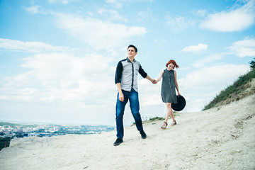 Man walking with woman on the top of the hill