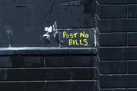 Post no bills, black wall