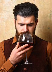 Service and catering concept. Sommelier with glass of red wine