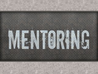 MENTORING painted on metal panel wall.