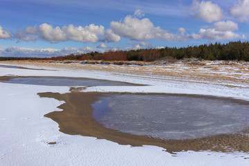The first snow on the beach in autumn