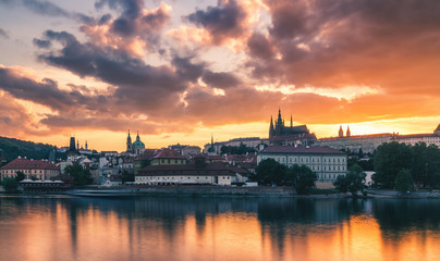 Fototapeta na wymiar Prague old town including Prague castle in the background, one of the most famous landmarks of Prague at sunset with dramatic sky.