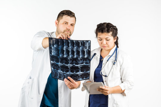 healthcare and medical concept, doctor and student looking at an x-ray. on a white background