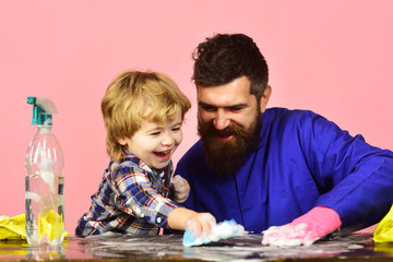 Man with cute child cleaning together with sponges and foam