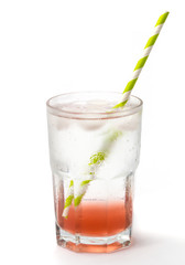 Close up of icy cold gin and tonic with cucumber and a straw