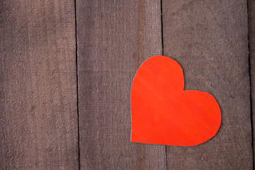 red heart on a background of brown wood