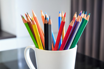 Colored pencils in the cup.