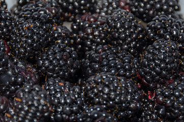 Bunch of blackberry fruits, wooden background, close up