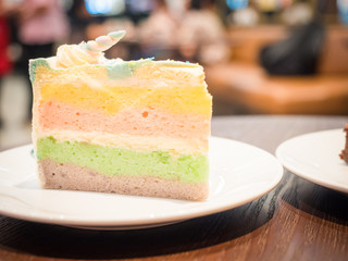 beauty layer from piece of cake serve in white dish and put on wooden table at vintage coffee shop on morning time