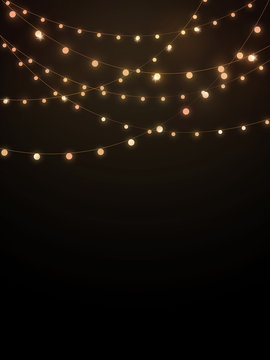 Gold string lights on black background
