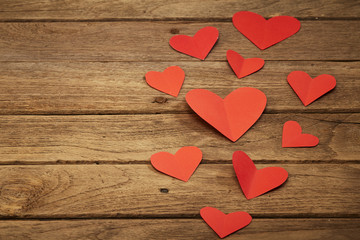 Red heart paper on wooden background
