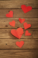 Obraz na płótnie Canvas Red heart paper on wooden background