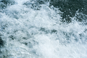Detail water in motion by speed from boat to lake
