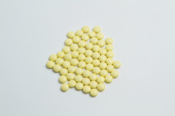 Yellow vitamins on white background . Medicines are prepared to patients